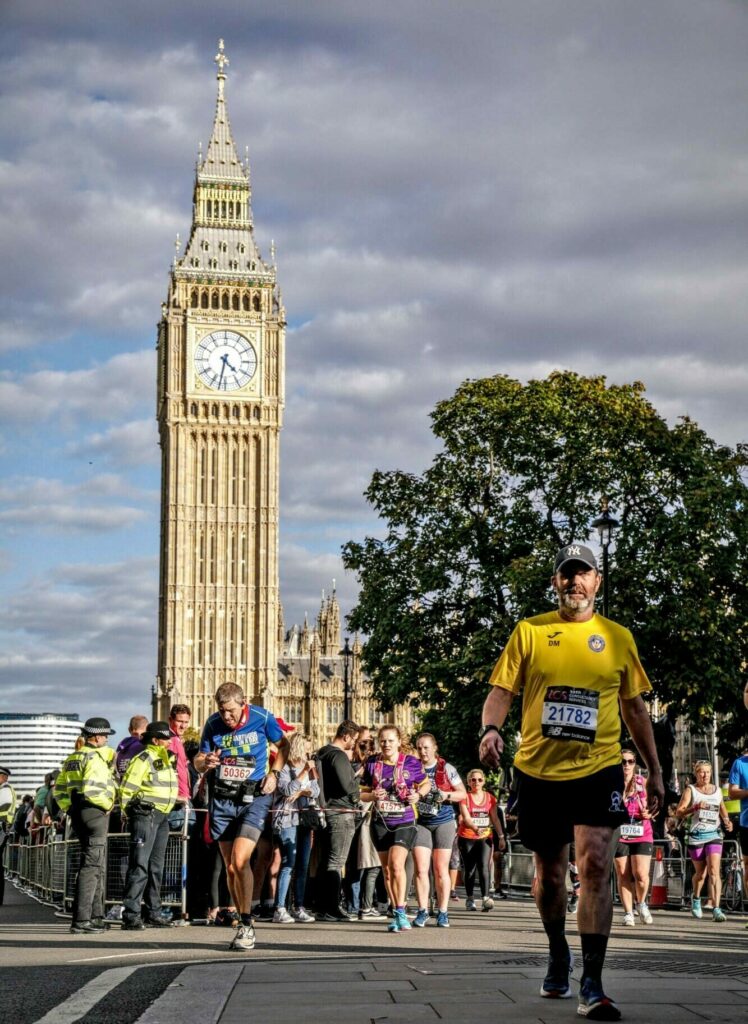 Man running the London Marathon with Big Ben in the backdrop.